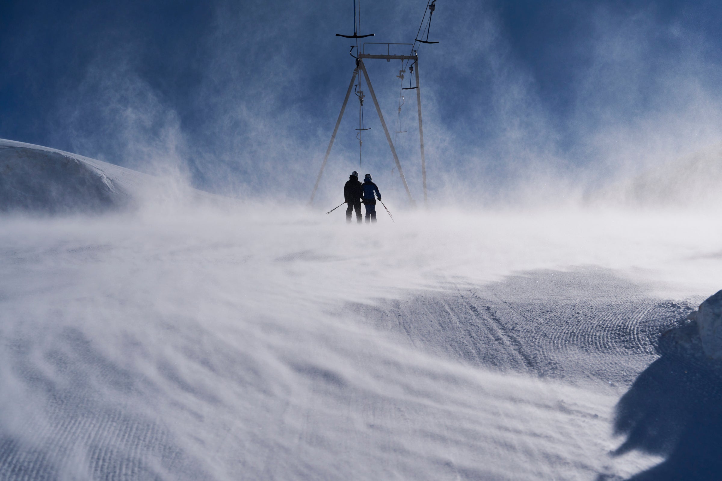 Two skiers on a snowy slope