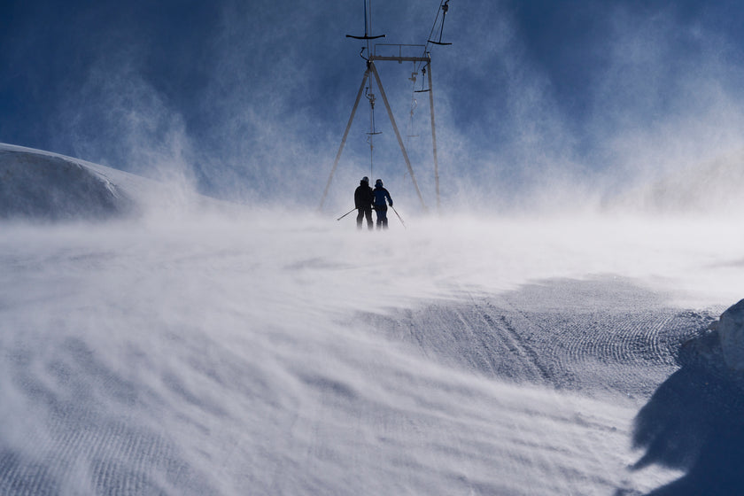 Two skiers on a snowy slope